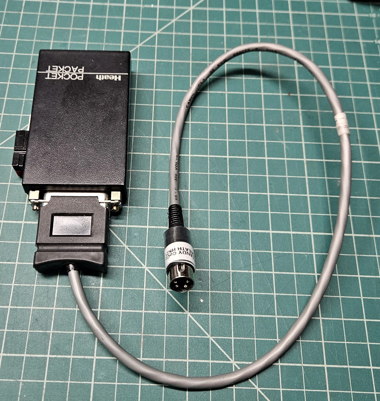 The same cable seen from the other side, showing the four pins of the DIN plug