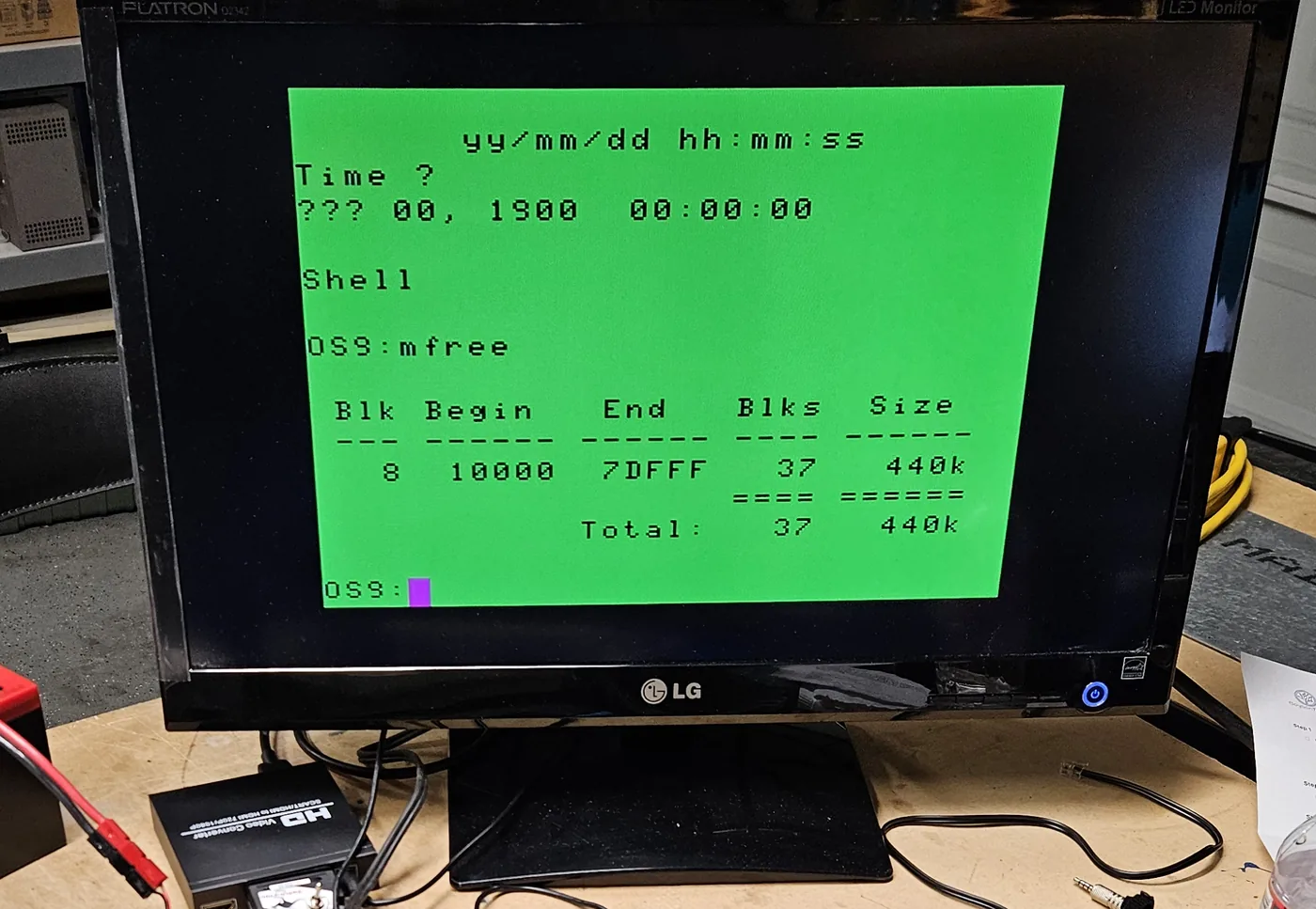 The monitor showing the OS-9 mfree command reporting a total of 440K free