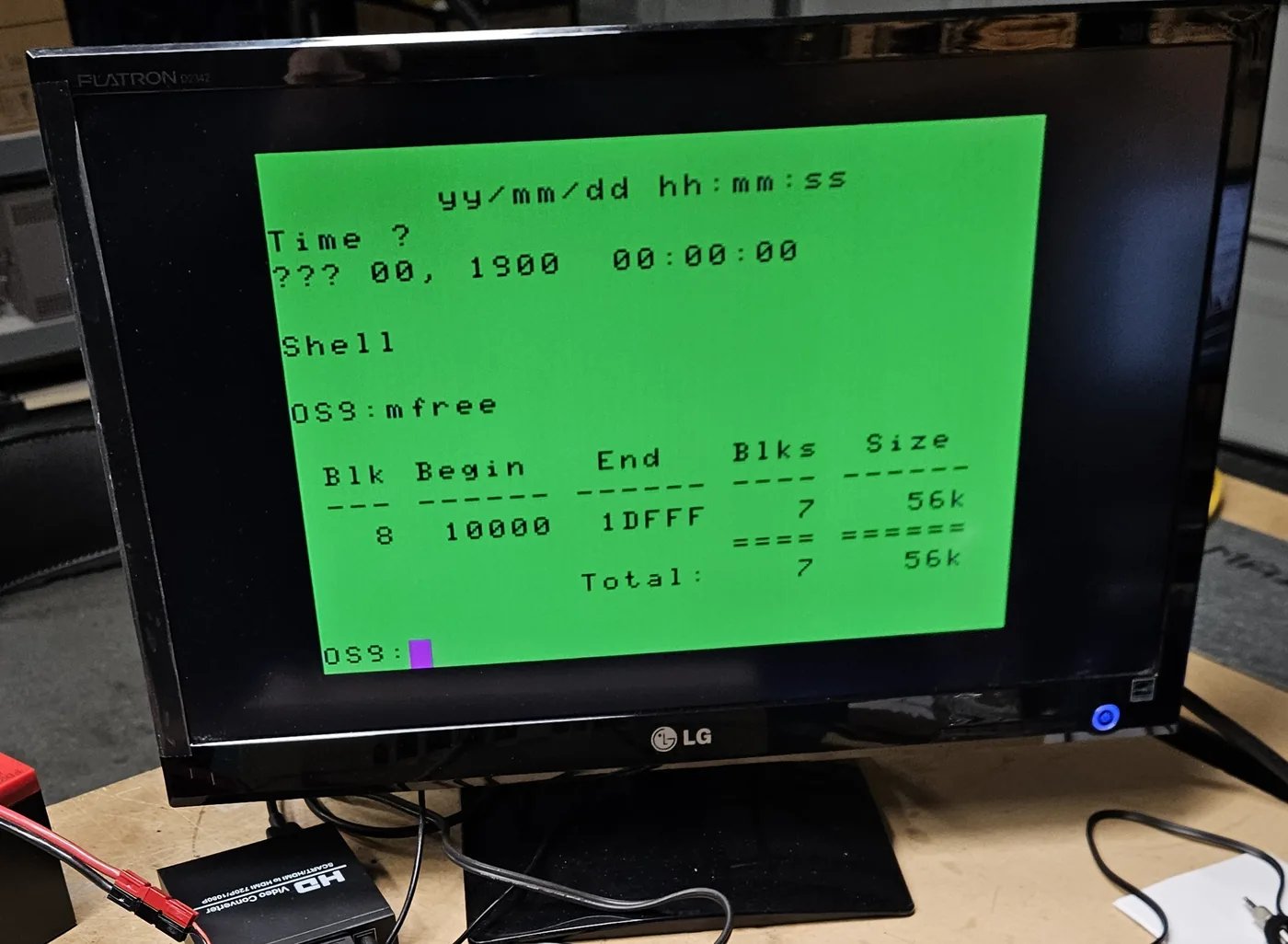 The monitor showing the OS-9 mfree command reporting a total of 56K free