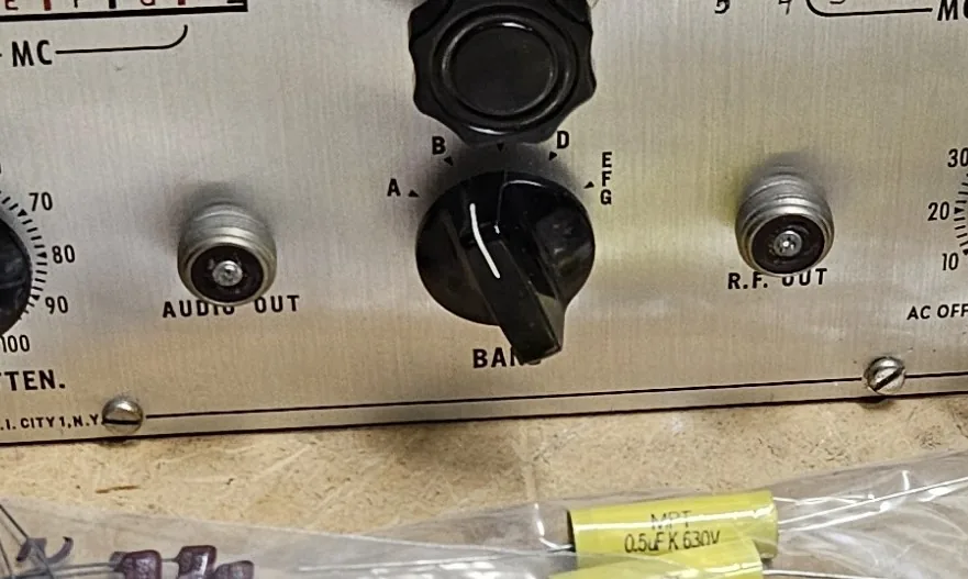 A close view of the front panel with the two original round screw-on connectors marked Audio Out and R.F. Out on either side of the band switch